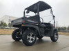 Trailmaster Taurus 200U Utility SXS UTV, black off-road vehicle with rugged tires and open cargo bed.