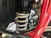 TrailMaster TM35X-250 Deluxe Dual-Sport Dirt Bike, close-up view of the motorcycle's suspension system with a white coil spring and black components.