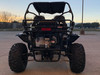 TrailMaster Cheetah 300EX Deluxe EFI Go-Kart/UTV Crossover, rear view of the off-road vehicle showing rugged tires, engine, and safety roll cage at sunset.