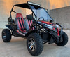 TrailMaster Cheetah 300EX Deluxe EFI Go-Kart and UTV Crossover, rugged off-road vehicle with red and black body, large off-road tires, dual red seats with seat belts, roll cage, and windshield.