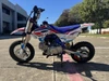 TrailMaster SK110S 110cc Semi-Automatic Kids Dirt Bike, yellow, black, white, and blue motocross motorcycle with knobby tires and suspension.