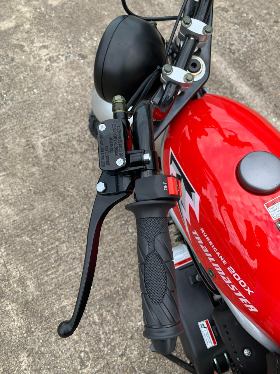 TrailMaster Hurricane 200X Mini Bike, close-up view of the handlebar with throttle grip and front suspension.