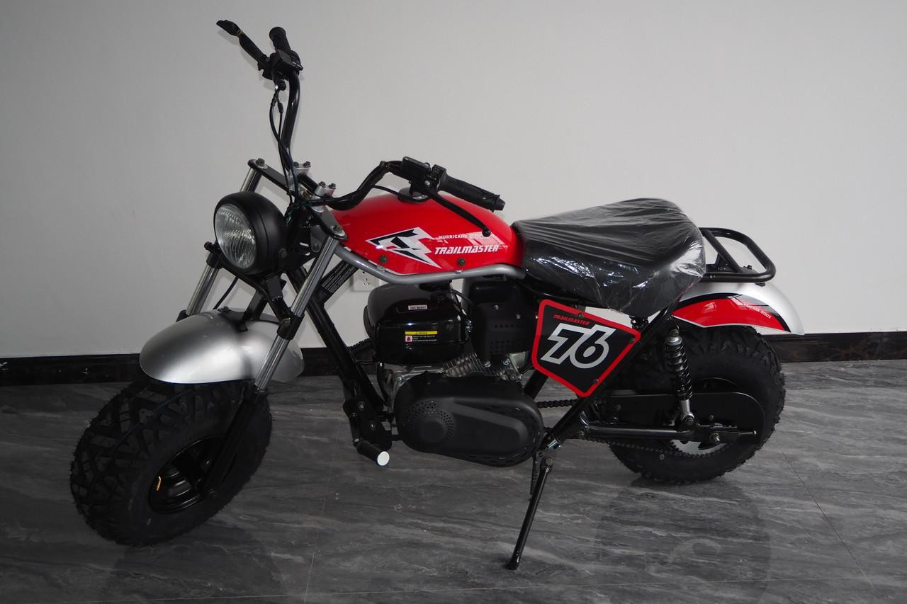 TrailMaster Hurricane 200X Mini Bike, red and black with racing number 56, black tires, and a headlight, displayed indoors.