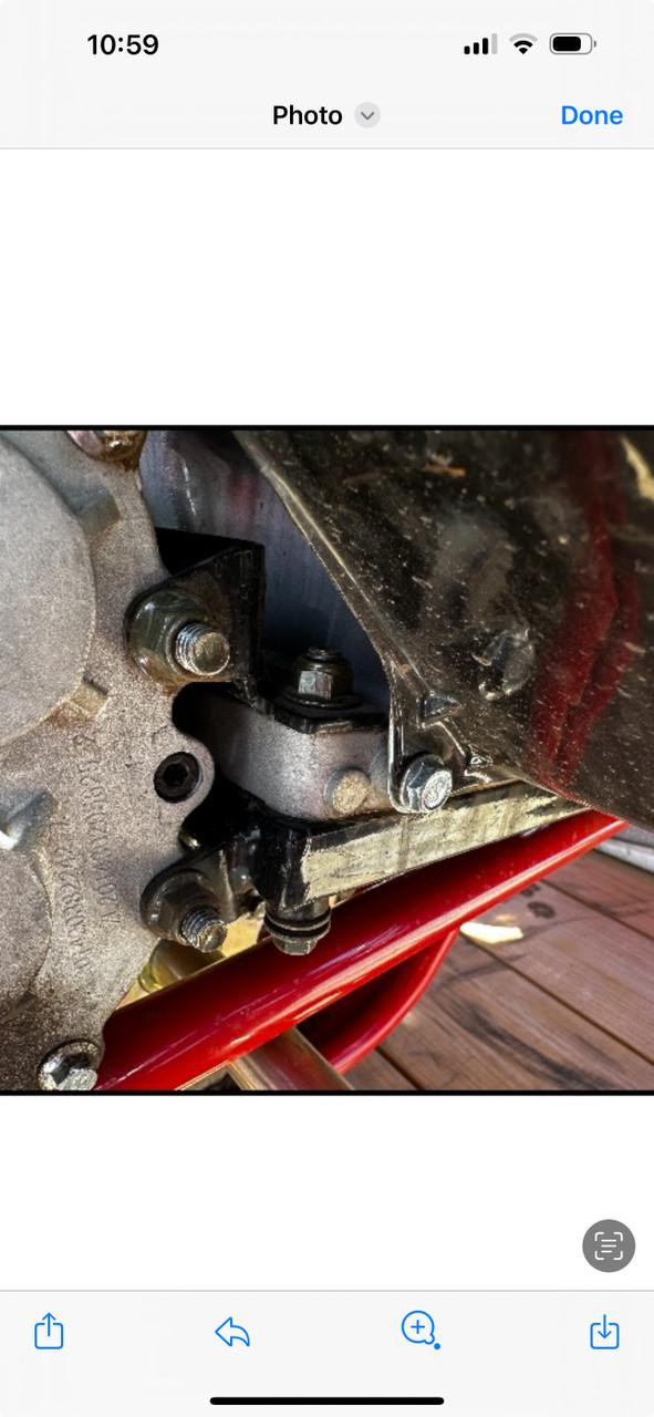 Special Order Mid XRX-R Reverse Box Top Mount, close-up view of mechanical component of an engine or machinery with bolts and metal parts.