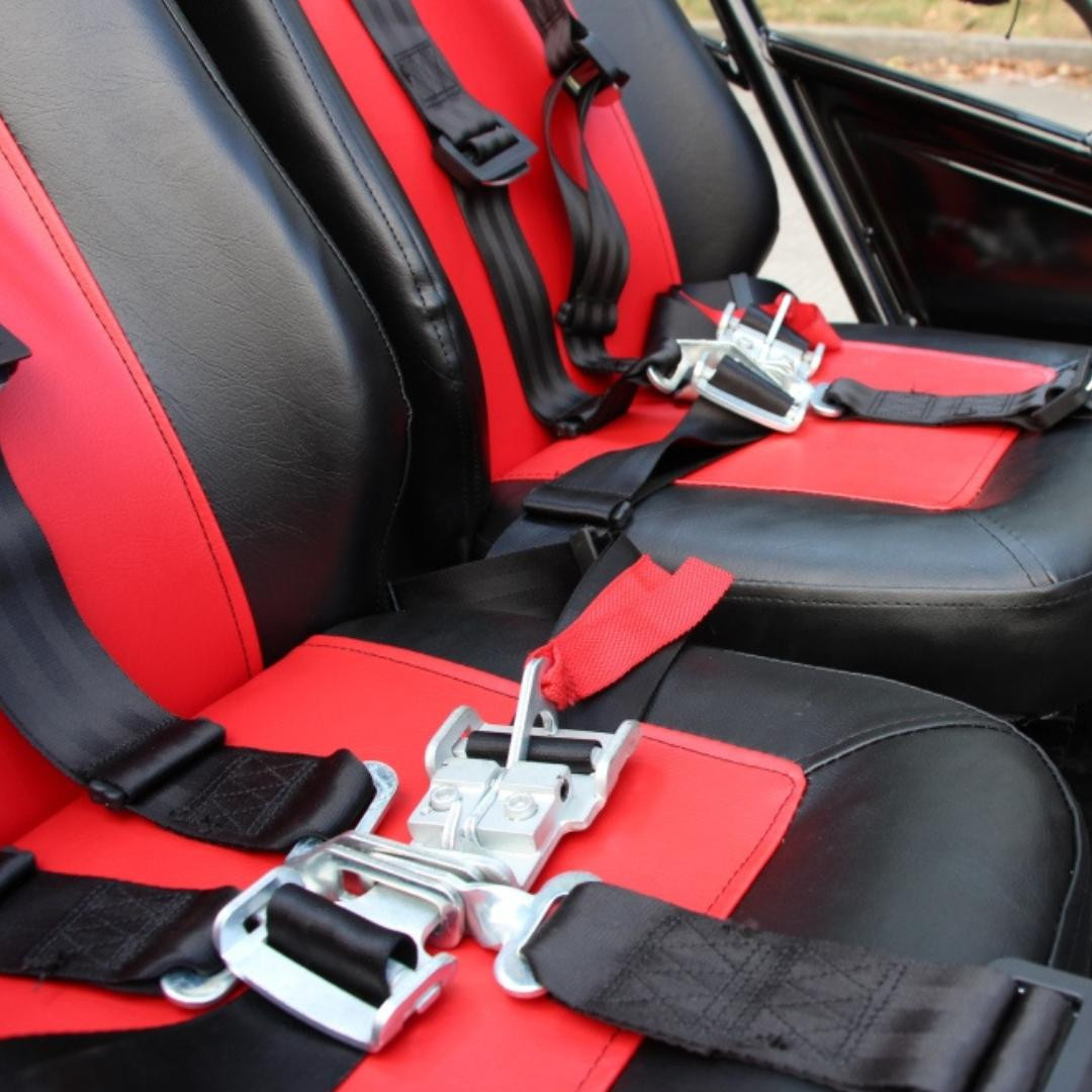 Trailmaster 150 XRS and 150 XRX Bucket Style Driver Side Seat Bottom with Rails, close-up of the black and red seat bottom with safety belts and metallic rails for off-road vehicle.