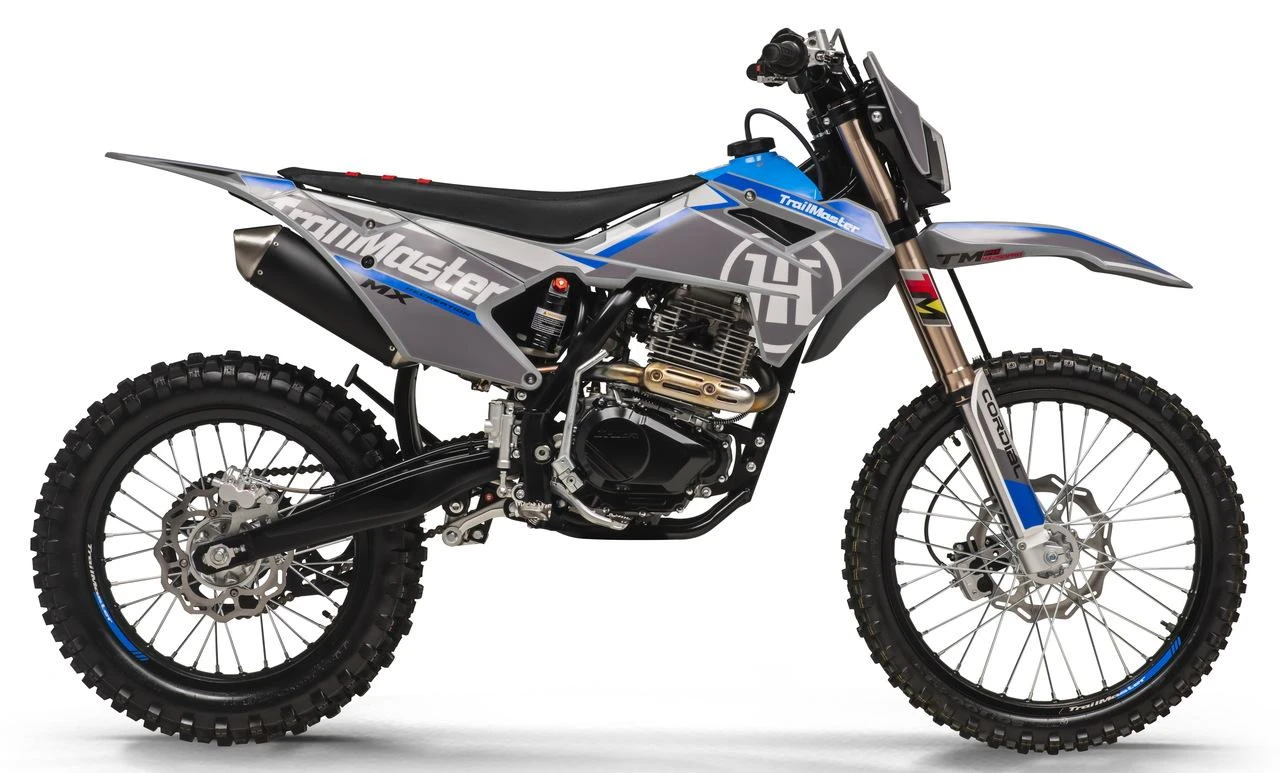Trailmaster MX250 Pro Dirt Bike, a modern off-road motorcycle featuring a sleek blue and gray body design with rugged tires, 35.5-inch seat height, manual transmission, and electric and kick start options.