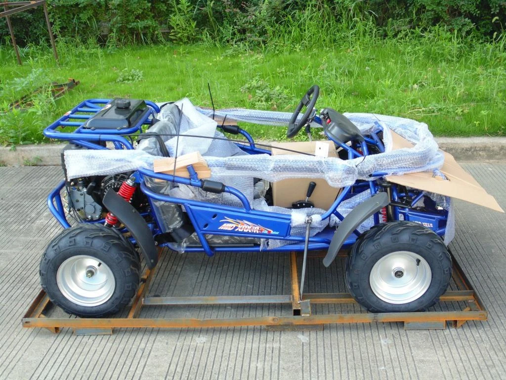 TrailMaster Mid XRX-R Go Kart for Kids, assembled blue off-road electric go-kart with 5-point harness, reverse, electric start, and protective packaging.