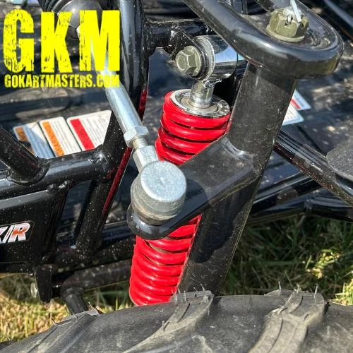 TrailMaster Mid XRX-R Go Kart For Kids with Reverse, Electric Start, 5 Point Harness, assembled showing suspension system with red coil shock absorber and part of the wheel