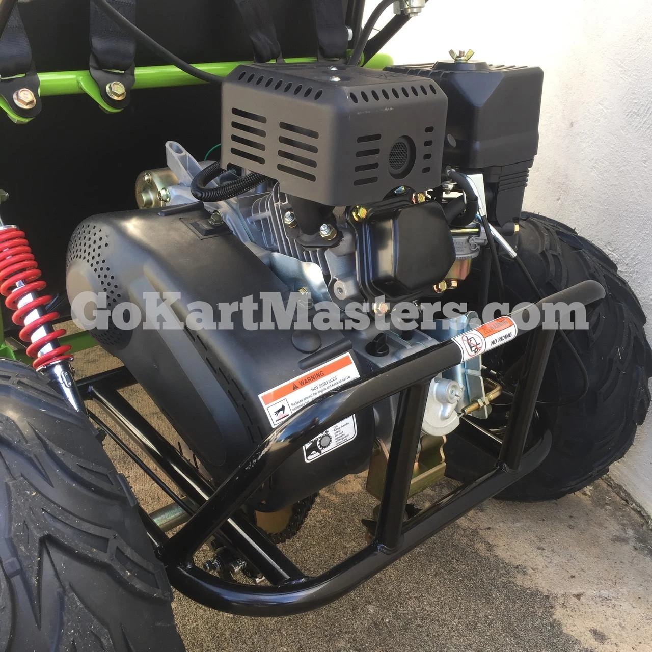 Assembled TrailMaster Mini XRX/R+ Go Kart with Reverse, showing its engine, black frame, and front wheel with thick tire.