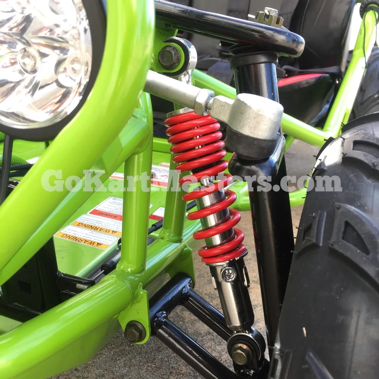 TrailMaster Mini XRX/R+ Go Kart with Reverse, assembled green and black go-kart with a red coil spring suspension system for ages 4 and up.