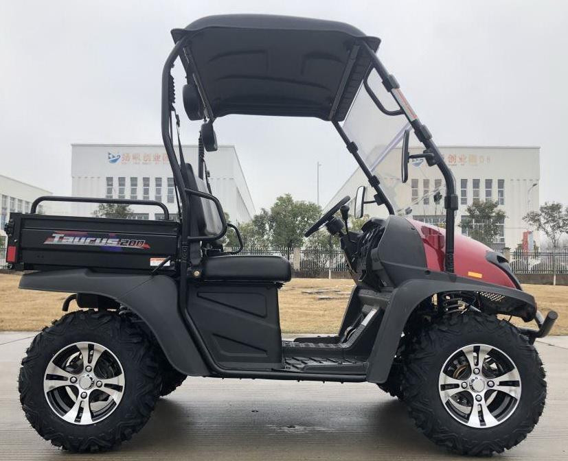 Trailmaster Taurus 200U utility SXS UTV, side view showing rugged tires, black and red body, and a canopy for outdoor utility and recreational use.