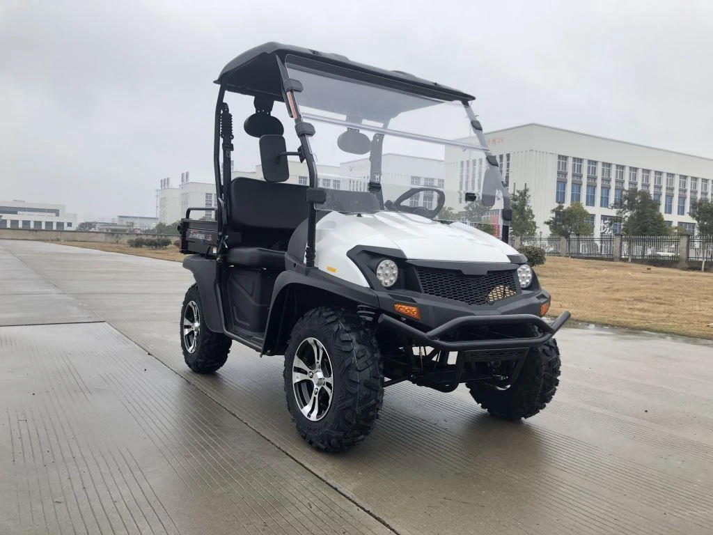 Trailmaster Taurus 200U Utility SXS UTV, four-wheel drive off-road utility vehicle with a sturdy black and white design, roof, clear windshield, large rugged tires, and seating for passengers.
