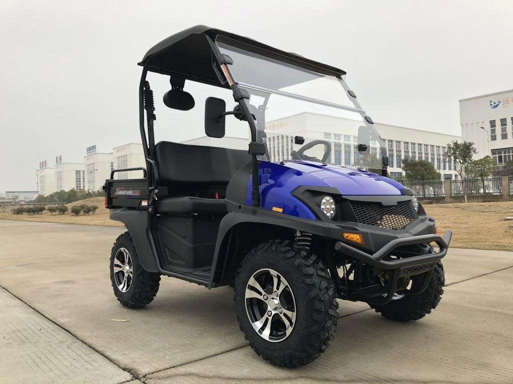 Trailmaster Taurus 200U Utility SXS UTV, off-road utility vehicle with large rugged tires, sturdy black bumper, and a black roof, parked on concrete pavement.