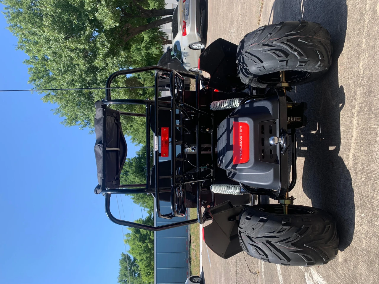 TrailMaster Blazer i2K Full-Size Electric Go-Kart, front view showing large off-road tires, black roll cage, and seating area.
