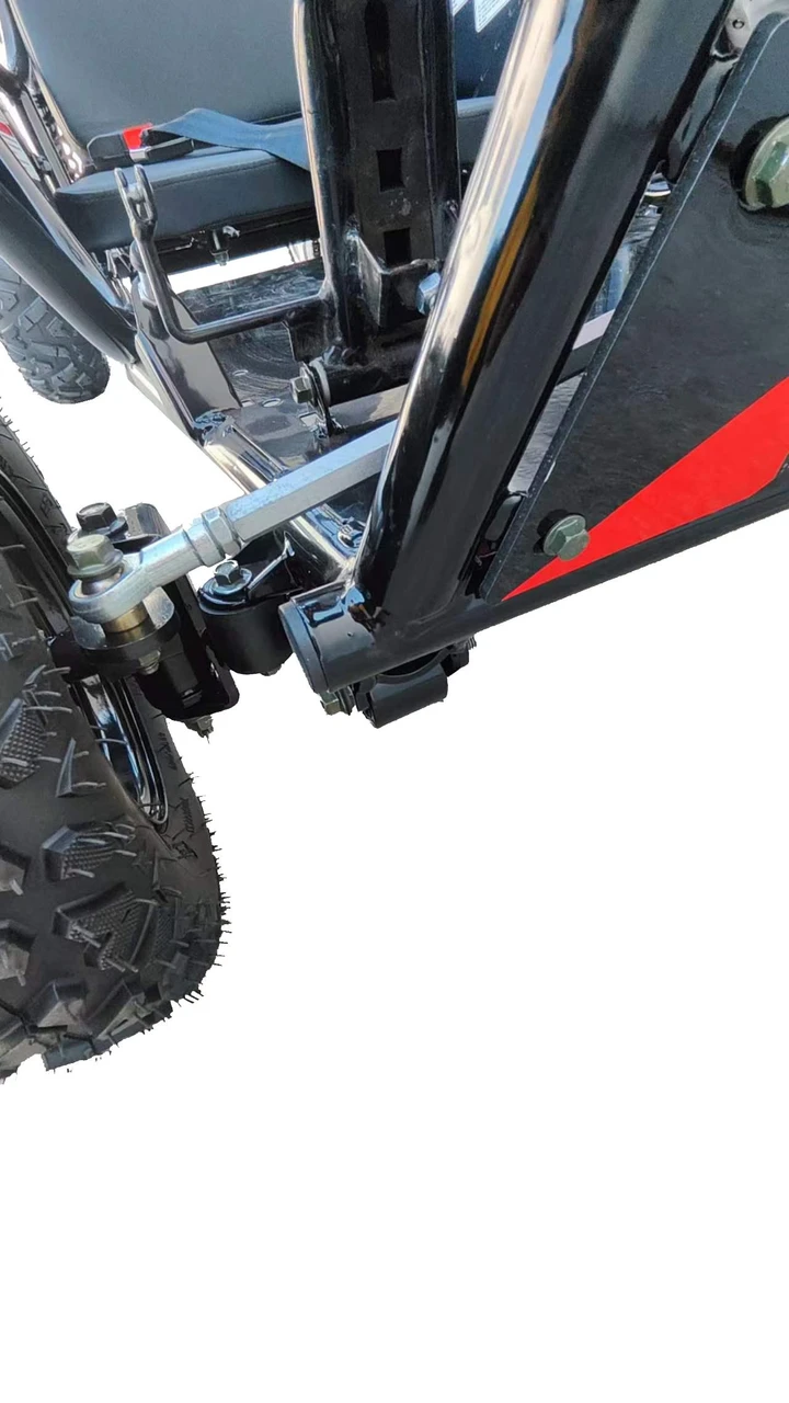 TrailMaster Cheetah 3 Kids Go-Kart, close-up view of the black chassis and rear wheel showing the suspension and tire tread.