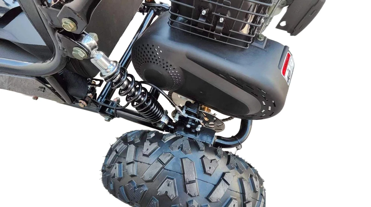 TrailMaster Cheetah 3 Kids Go-Kart, close-up view of the rear wheel and engine showcasing rugged tires and durable construction.