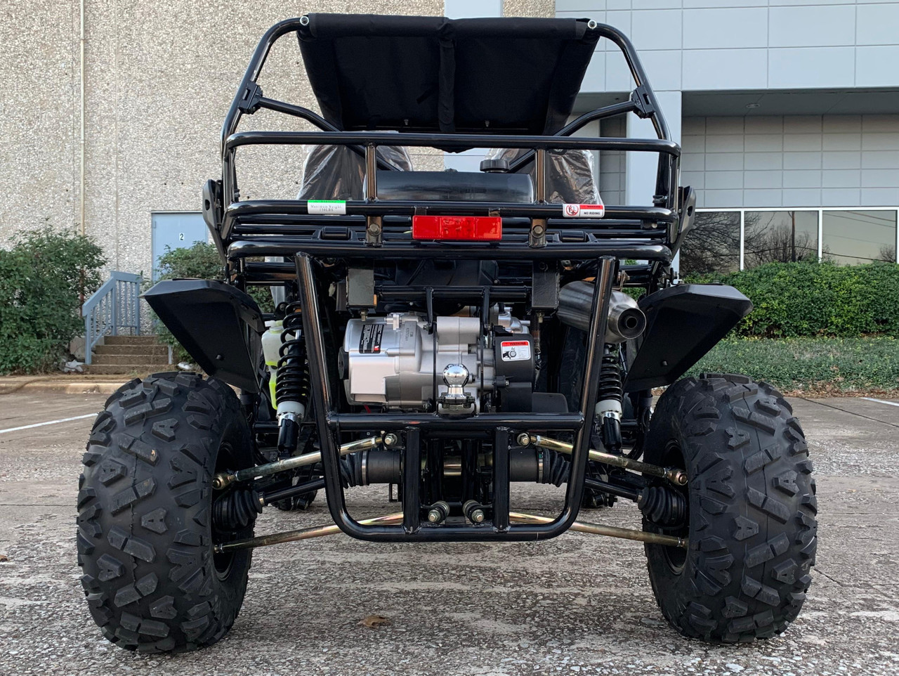 TrailMaster Cheetah 300EX Deluxe EFI Go-Kart/UTV Crossover, front view of the off-road vehicle showing large rugged tires, black frame, and engine components.