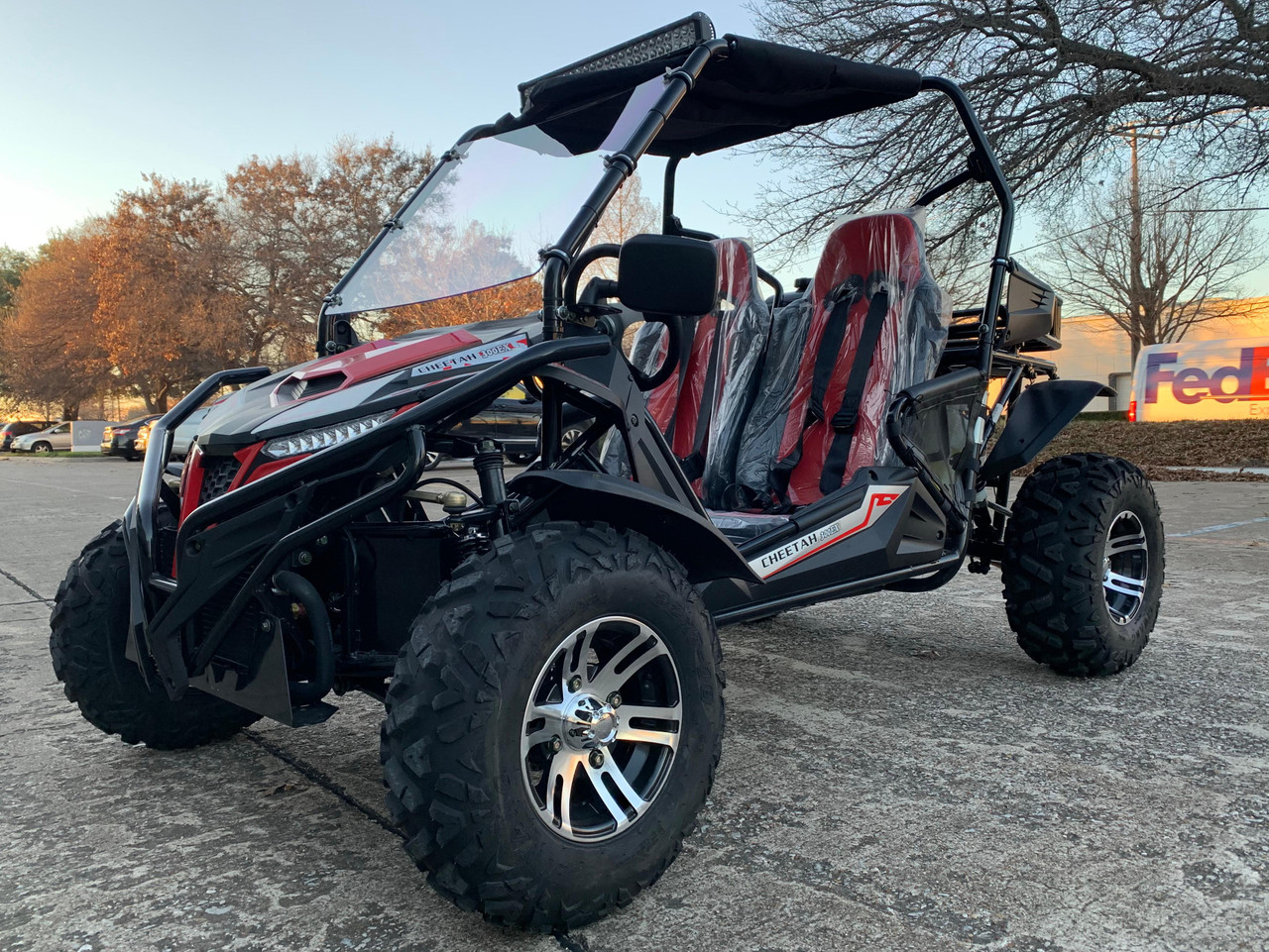 TrailMaster Cheetah 300EX Deluxe EFI Go-Kart/UTV Crossover, black and red off-road go-kart with large tires, roll cage, and seating for two with protective covers.