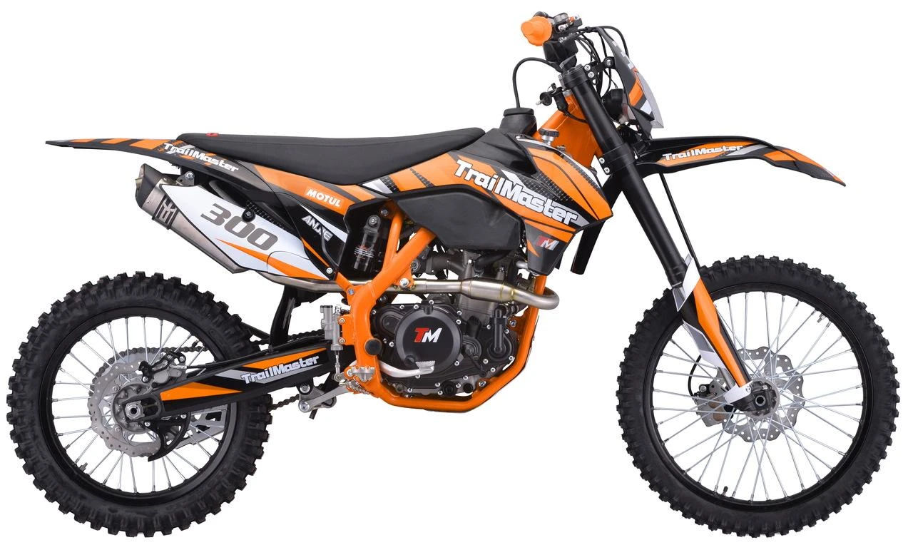 TrailMaster TM38E-300 EFI Full-Size Manual Dirt Bike, orange and black off-road motorcycle with knobby tires, front and rear disc brakes, and a lightweight frame.