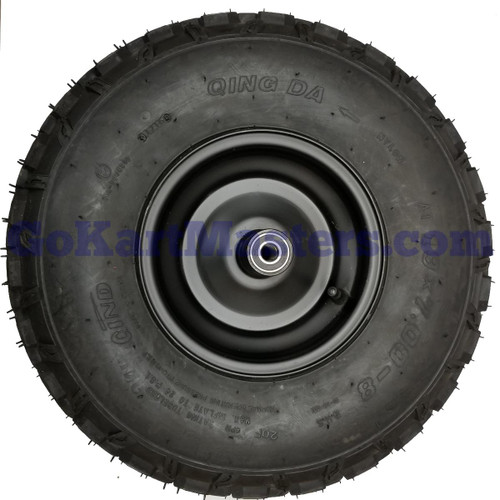 TrailMaster MB200-2 Mini Bike Front Wheel And Tire, close-up of a black knobby tire mounted on a metal wheel with a central bearing.