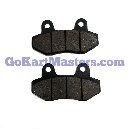 TrailMaster MB200-2 Brake Pad Set/Hydro, two black brake pads with worn friction surfaces for scooter or ATV braking system.