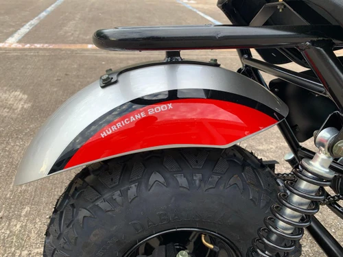 TrailMaster Hurricane 200X Mini Bike, close-up of the front wheel with a black and red fender and a chunky off-road tire.