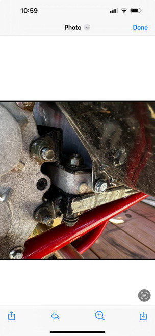 Special Order Mid XRX-R Reverse Box Top Mount, close-up view of mechanical component of an engine or machinery with bolts and metal parts.