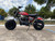 TM Hurricane 200X PRO Mini Bike with Electric Start, red and black mini motorcycle with number 36 on side panel and knobby tires, parked outdoors on a concrete surface.