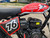 TM Hurricane 200X PRO Mini Bike with Electric Start, red fuel tank, black engine, and racing number 16 on the side, suitable for off-road riding.