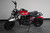 TM Hurricane 200X PRO Mini Bike with Electric Start, red and black mini motorcycle with number 56 decal, front headlight, black seat covered with plastic, sturdy tires, and minimalistic design.