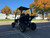 TM Cheetah i6 Battery Powered Golf Cart, outdoor scene with trees, parking lot and blue sky.