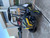 TM Cheetah i6 Battery powered, off-road electric vehicle with four large tires, black and yellow color, and protective canopy, parked outside a building.