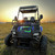 TM Challenger 200 EUX | YOUTH SXS | EFI | UTILITY BED | PREMIUM PACKAGE, an off-road utility side-by-side vehicle with a sturdy black metal frame, rugged tires, and a spacious utility bed, designed for youth outdoor activities and work use.