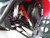 TM Challenger 300 EX 300cc SXS, close-up view of its suspension system with a red coil shock absorber, rugged tire, and chassis components.