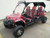 TM Challenger 4 200 EX 4 Seater 200cc SXS, red and black off-road utility vehicle with four seats, rugged tires, and protective roof for outdoor adventures.