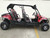 TM Challenger 4 200 EX 4 Seater 200cc SXS, red and black off-road utility vehicle with four seats, roll cage, and rugged tires.