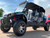 TM Challenger 4 200 EX 4 Seater 200cc SXS, off-road utility vehicle with four seats, rugged tires, and a protective canopy, suitable for outdoor adventures.