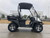 TM Taurus200/EU Side by Side, black and white utility vehicle with rugged tires, open cabin, and cargo bed, designed for off-road and outdoor utility tasks.
