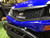 TM Taurus200/EU Side by Side, close-up of a blue utility vehicle front with black grille, TM logo, and chrome bumper.