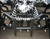 TM 3050c Mini 110cc ATV, front view showcasing black metal frame, suspension springs, and handlebars.