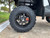 TM 4x4 SportsCross 1000 Side by Side, close-up of the tire and wheel showing rugged off-road tire and stylish black rim with disc brakes.