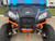 TM 4x4 SportsCross 1000 Side by Side, front view showing the aggressive design, large off-road tires, and vibrant orange suspension bars.