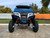 TM 4x4 SportsCross 1000 Side by Side, front view of the blue and black off-road vehicle with large rugged tires and suspension system.