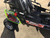 TM Mid Size Blazer 200R Go Kart with Reverse, side view showing black seats, steering wheel, and vibrant graphics on the body, including the Trailmaster logo and red suspension.