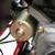 TM Mid XRX Go Kart for age 8 and up, close-up of engine and mechanical components showing metallic parts and wiring.