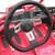 TM Mid XRX Go Kart for age 8 and up, close-up of the black steering wheel with metallic accent and dashboard details.