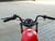 TM MB200-2 Mini Bike, front view of the handlebars and red fuel tank.