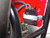 TM MB200-2 Mini Bike, close-up of the black ignition coil mounted on a red metal frame with attached gray wires.