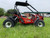 TM 200 XRX EFI PREMIUM Go Kart, red off-road go-kart with large tires and roll cage for off-road racing.