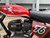TM Hurricane 200X Upgraded Mini Bike, close-up view of the red fuel tank with 'HURRICANE 200X' and 'TRAILMASTER' branding, along with the black engine and a red and black numbered plate.